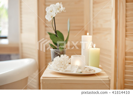 set for spa procedure with towel for bathroom procedures, burning candles and flowers set for spa procedure with towel for bathroom procedures, burning candles and flowers 41814410