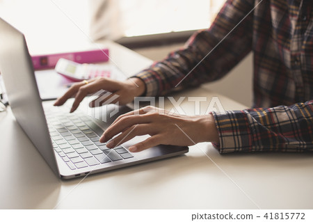 Businessman hands busy using laptop at office desk Businessman hands busy using laptop at office desk 41815772
