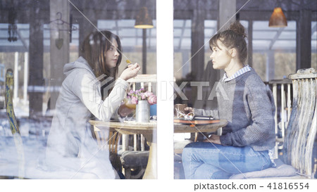 Two female friends meeting in a cafe to talk Two female friends meeting in a cafe to talk 41816554