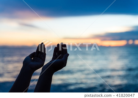 Soft focus and silhouette woman hands praying Soft focus and silhouette woman hands praying 41820047