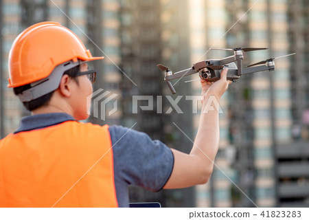 Asian engineer holding drone at construction site Asian engineer holding drone at construction site 41823283