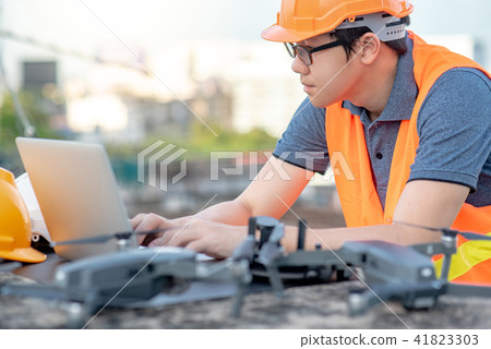 Male worker using drone and laptop for site survey 41823303