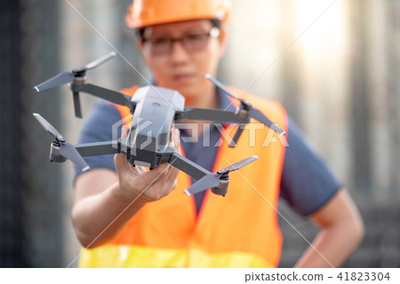 Asian engineer holding drone at construction site 41823304