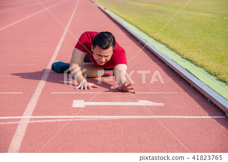 Sad man sitting on the floor after losing  41823765