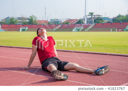 Sad man sitting on the floor after losing  41823767