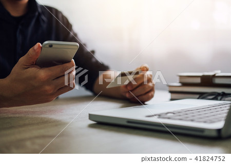 Man typing laptop and using smartphone for online shopping and p Man typing laptop and using smartphone for online shopping and p 41824752