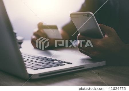 Man typing laptop and using smartphone for online shopping and p 41824753