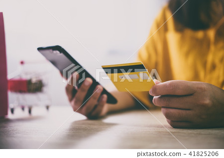 Image of Young woman using smartphone for online shopping websit Image of Young woman using smartphone for online shopping websit 41825206