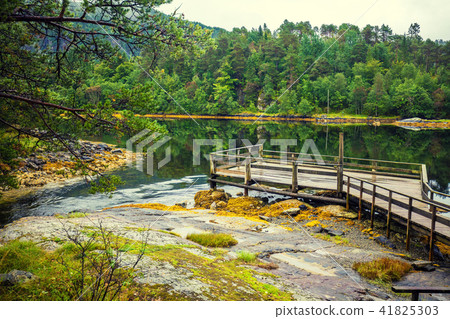 Wooden deck on a lakeshore Wooden deck on a lakeshore 41825303