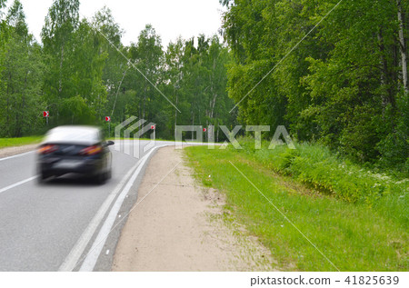 Moving black car on the road 41825639