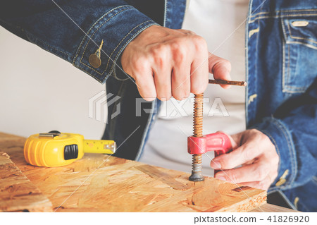 Carpenter working carefully looking at the plans work in carpent Carpenter working carefully looking at the plans work in carpent 41826920