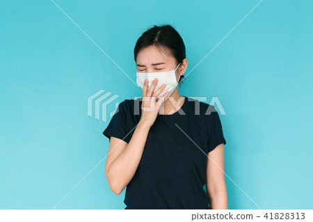 Young woman having headache on blue background. 41828313