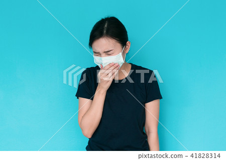 Young woman having headache on blue background. Young woman having headache on blue background. 41828314