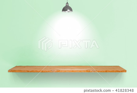 Wooden shelf with lamp on green vintage wall. 41828348
