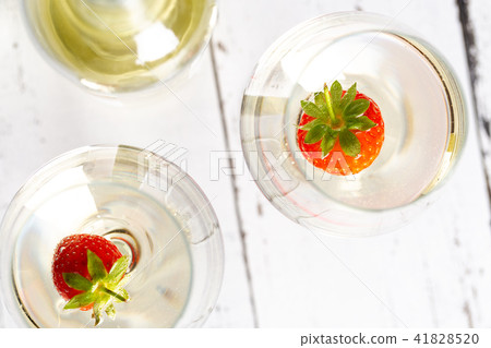 Two wine glasses with white wine and strawberry. Two wine glasses with white wine and strawberry. 41828520