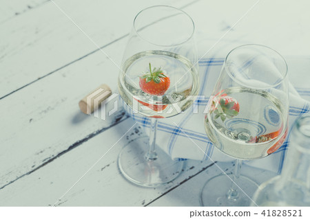 Two wine glasses with white wine and strawberry. Two wine glasses with white wine and strawberry. 41828521