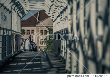 Young cuddling couple on railway bridge. Young cuddling couple on railway bridge. 41828586