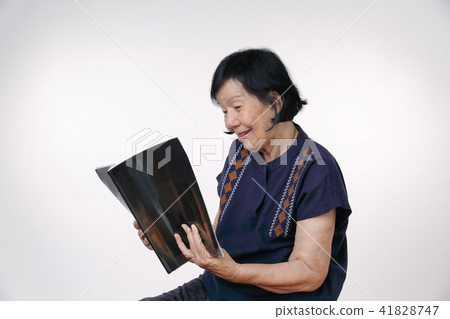 elderly woman reading a magazine elderly woman reading a magazine 41828747