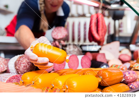 Butcher shop woman holding meat in her hand Butcher shop woman holding meat in her hand 41828919