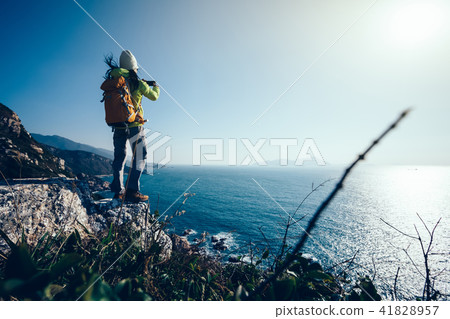 Hiker Using Smartphone taking photo at Seaside Hiker Using Smartphone taking photo at Seaside 41828957