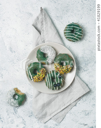 Vegan donuts topped spirulina glaze 41829199