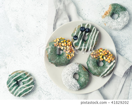 Vegan donuts topped spirulina glaze 41829202