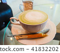 Fresh green tea with tea leaves in the water 41832202