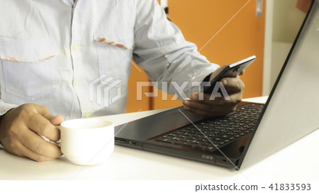 using laptop and smartphone drinking coffee  41833593