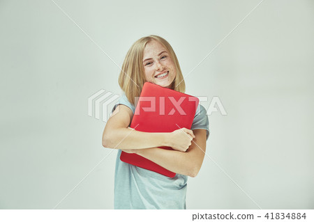 Businesswoman hugging laptop. Love to computer concept. Attractive female half-length front portrait Businesswoman hugging laptop. Love to computer concept. Attractive female half-length front portrait 41834884