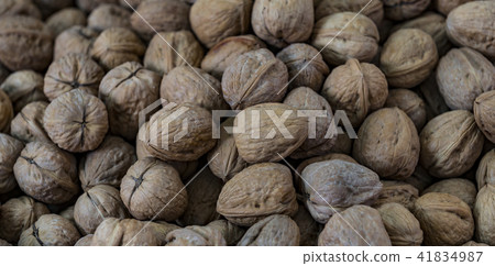 Background of a walnut in a wicker basket close-up Background of a walnut in a wicker basket close-up 41834987
