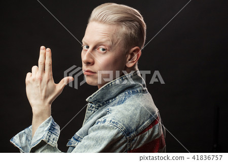 Handsome blonde american man in denim jaket isolated over black background 41836757