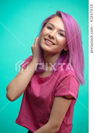 Young female model with pink hair, smiling broadly, feeling joy. Young female model with pink hair, smiling broadly, feeling joy. 41837018