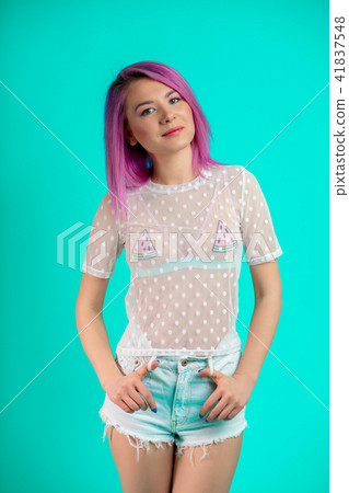 Fit woman with violet hair, dressed in transparent blouse and shorts isolated Fit woman with violet hair, dressed in transparent blouse and shorts isolated 41837548