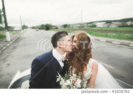 Happy bride and groom posing after wedding ceremony Happy bride and groom posing after wedding ceremony 41838762