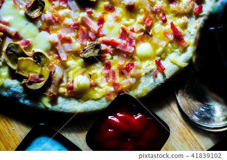 Delicious pizza with bacon, ham, mushrooms  41839102