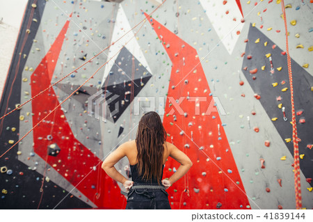 Athletic woman preparing for rope climbing exercise at the local gym b 41839144