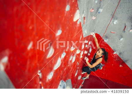 High angle view of woman practicing wall climbing on a campus board. Woman climbing on a campus 41839150