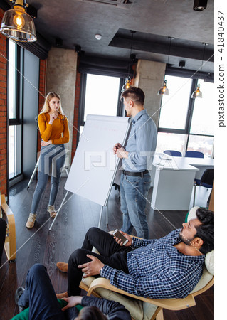 Multi-ethnic people planning business strategy with scheme on flip chart 41840437