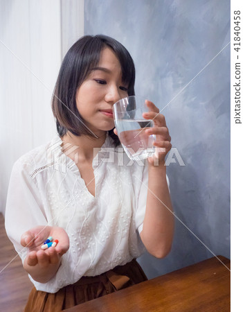 Girl taking medicine 41840458