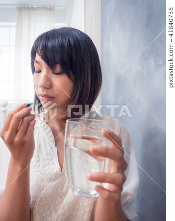 Girl taking medicine Girl taking medicine 41840738