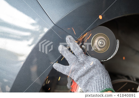Close up hand cutting to extending wheel arch Close up hand cutting to extending wheel arch 41840891