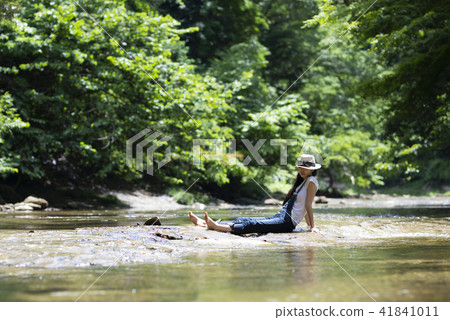 A woman relaxing on the river A woman relaxing on the river 41841011