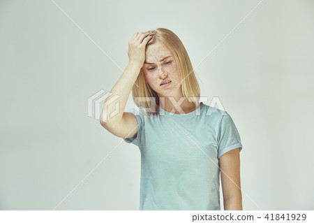 Woman having headache. Isolated over pastel background. Woman having headache. Isolated over pastel background. 41841929