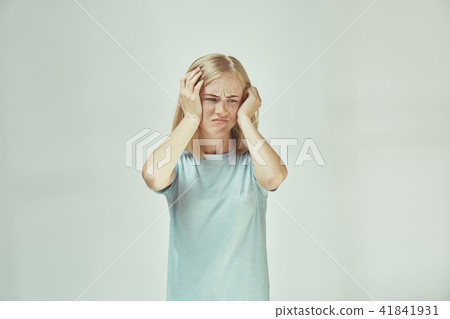 Woman having headache. Isolated over pastel background. Woman having headache. Isolated over pastel background. 41841931