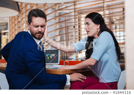Insulted woman slapping her boss in the face Insulted woman slapping her boss in the face 41844118