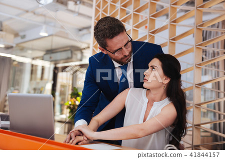 Sensual man touching his colleagues hand Sensual man touching his colleagues hand 41844157