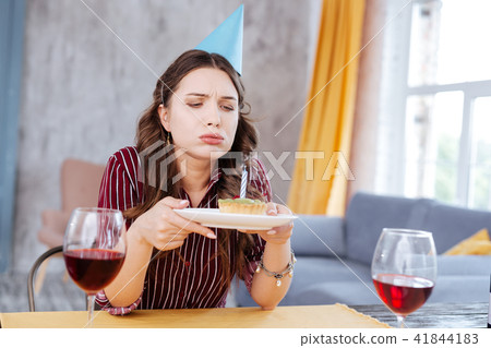 Birthday girl blowing out little candle on birthday muffin 41844183