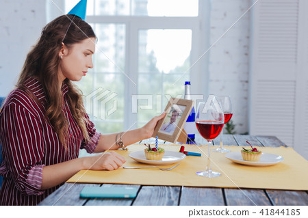 Sad woman looking at photo of her ex boyfriend Sad woman looking at photo of her ex boyfriend 41844185