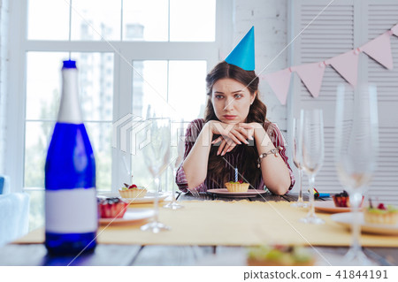 Birthday woman feeling bored waiting for her guests 41844191