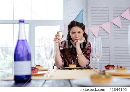 Dark-haired woman feeling mindful while drinking champagne 41844193